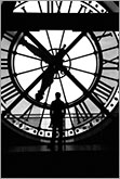 Time passing by - conceptual black and white image of man silhouette against big clock
